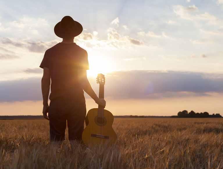 Tamworth Oral Health and Dental Care | Man in a field looking at the sunset